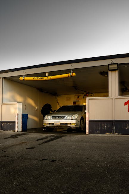 A car entering a car wash with a clearance sign, photographed in Toronto, Canada.